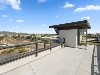 the view of the city from the balcony of a building with a glass door at Scottsdale Grand, Arizona